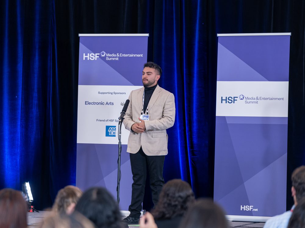 Santiago Reyes speaking on stage at the HSF Media and Entertainment Summit