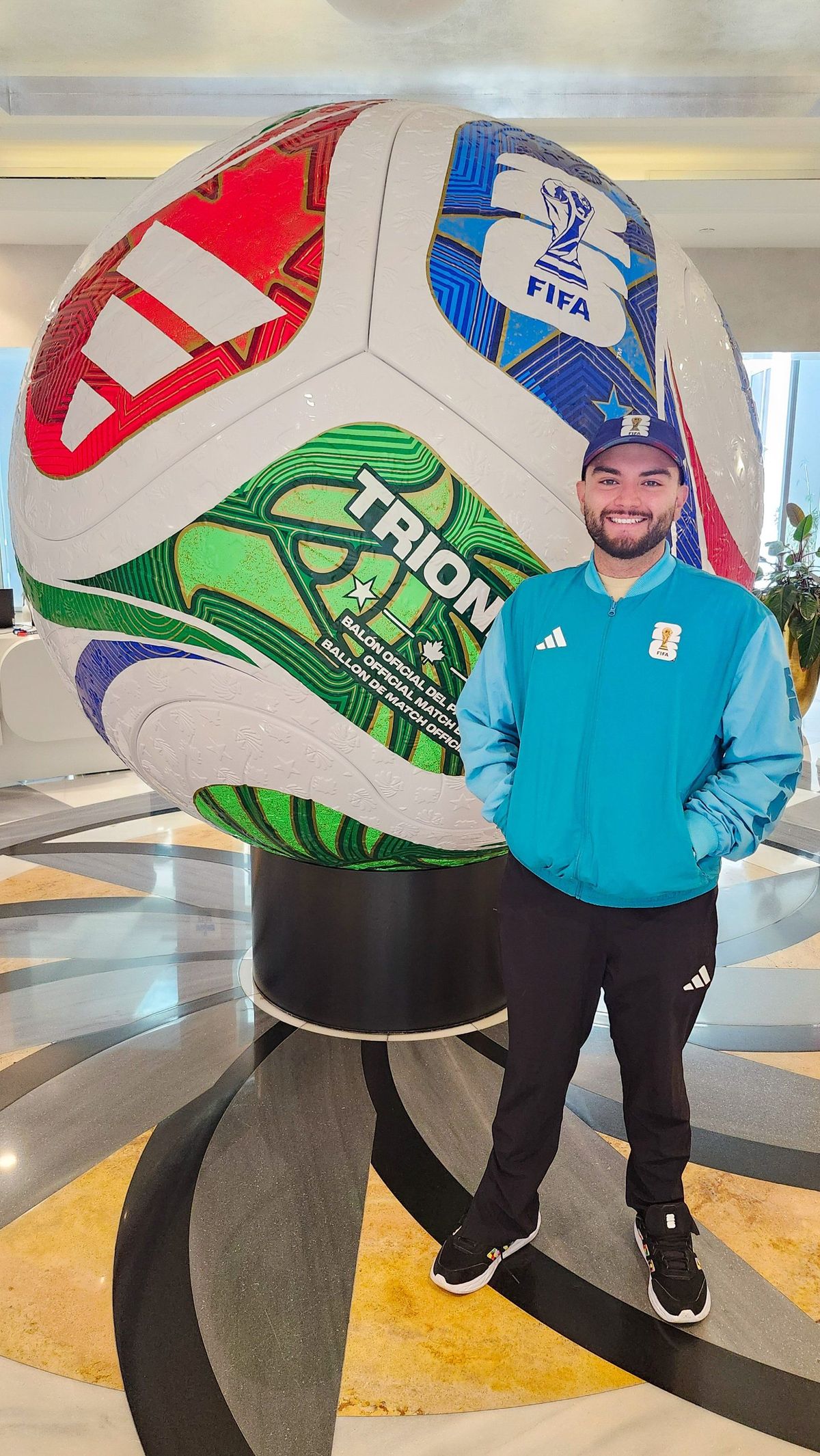 Santiago Reyes with the giant official match ball display at the FIFA World Cup 2026